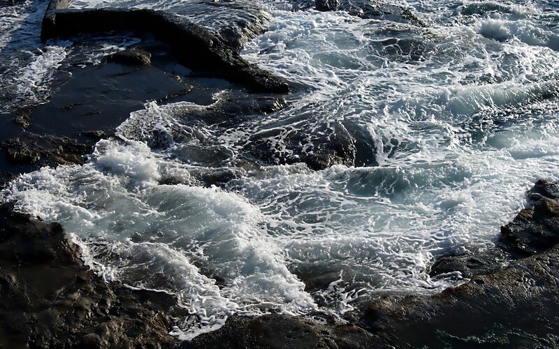 Waves crashing on rocky shore