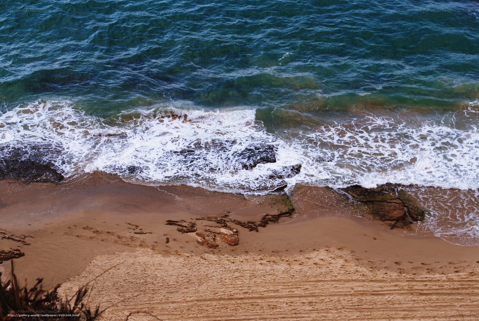 Waves crashing on sandy beach