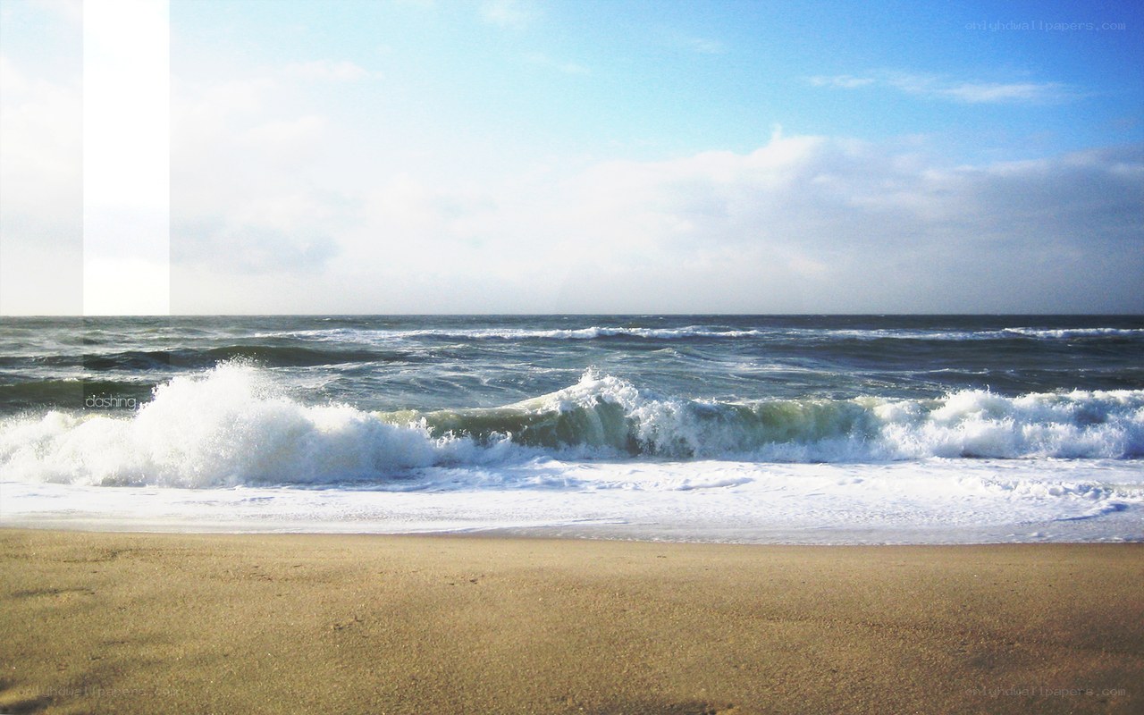 Waves crashing on sandy beach