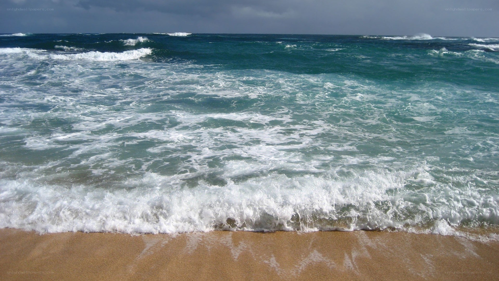 Waves crashing on sandy beach