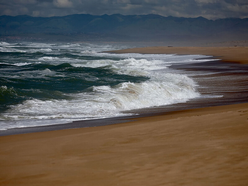 Waves crashing on sandy beach