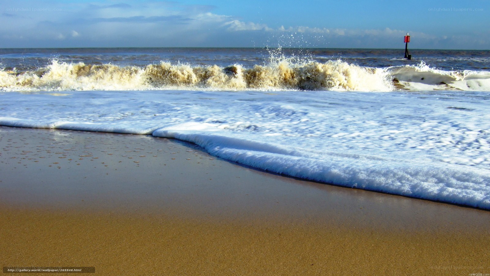 Waves crashing on sandy beach