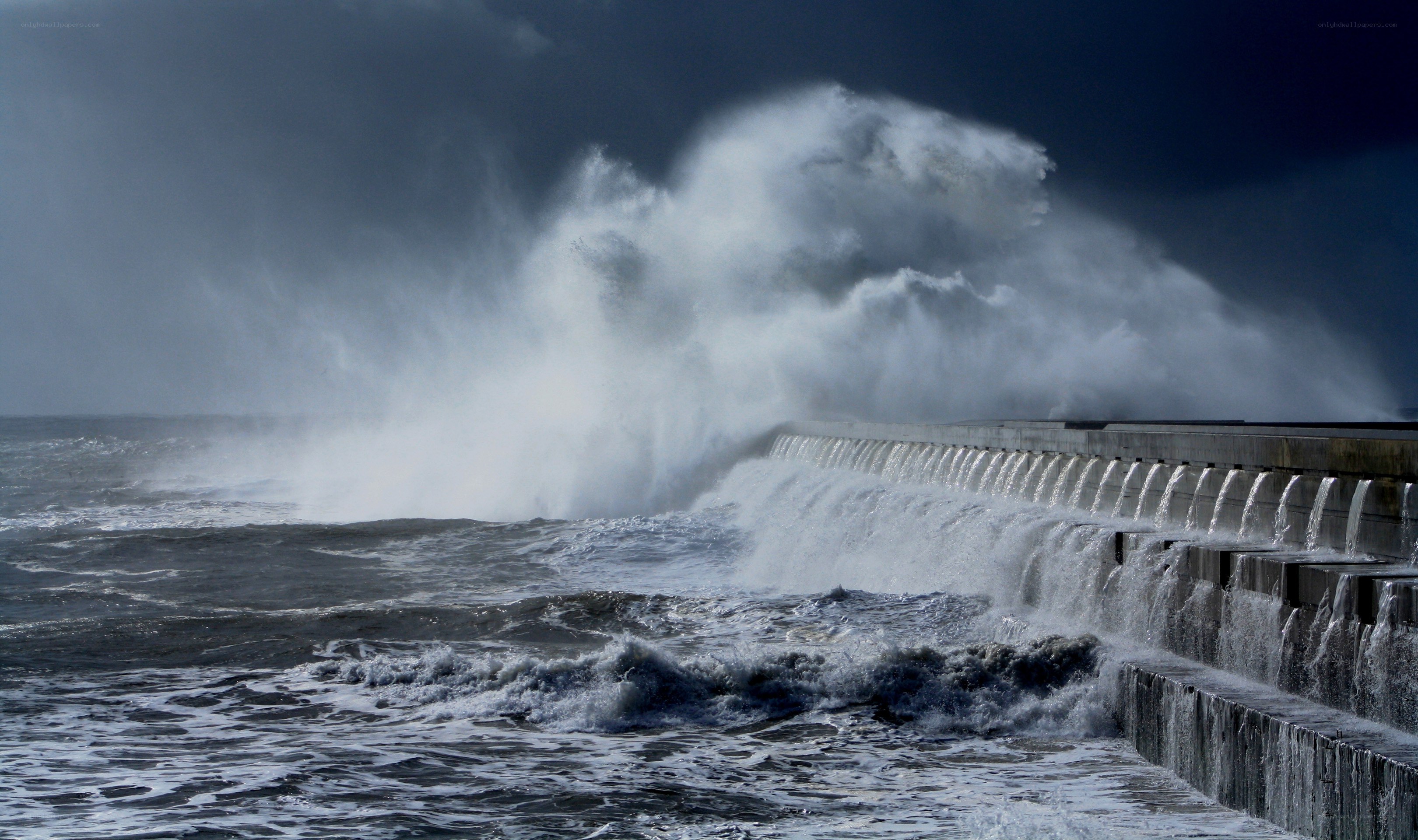 Waves crashing on sea wall