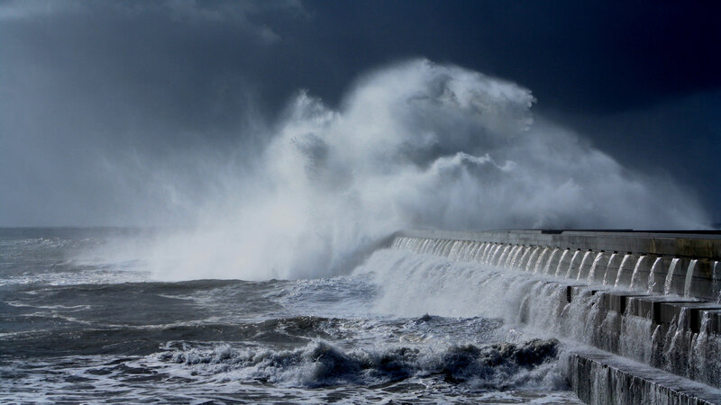 Waves crashing on sea wall