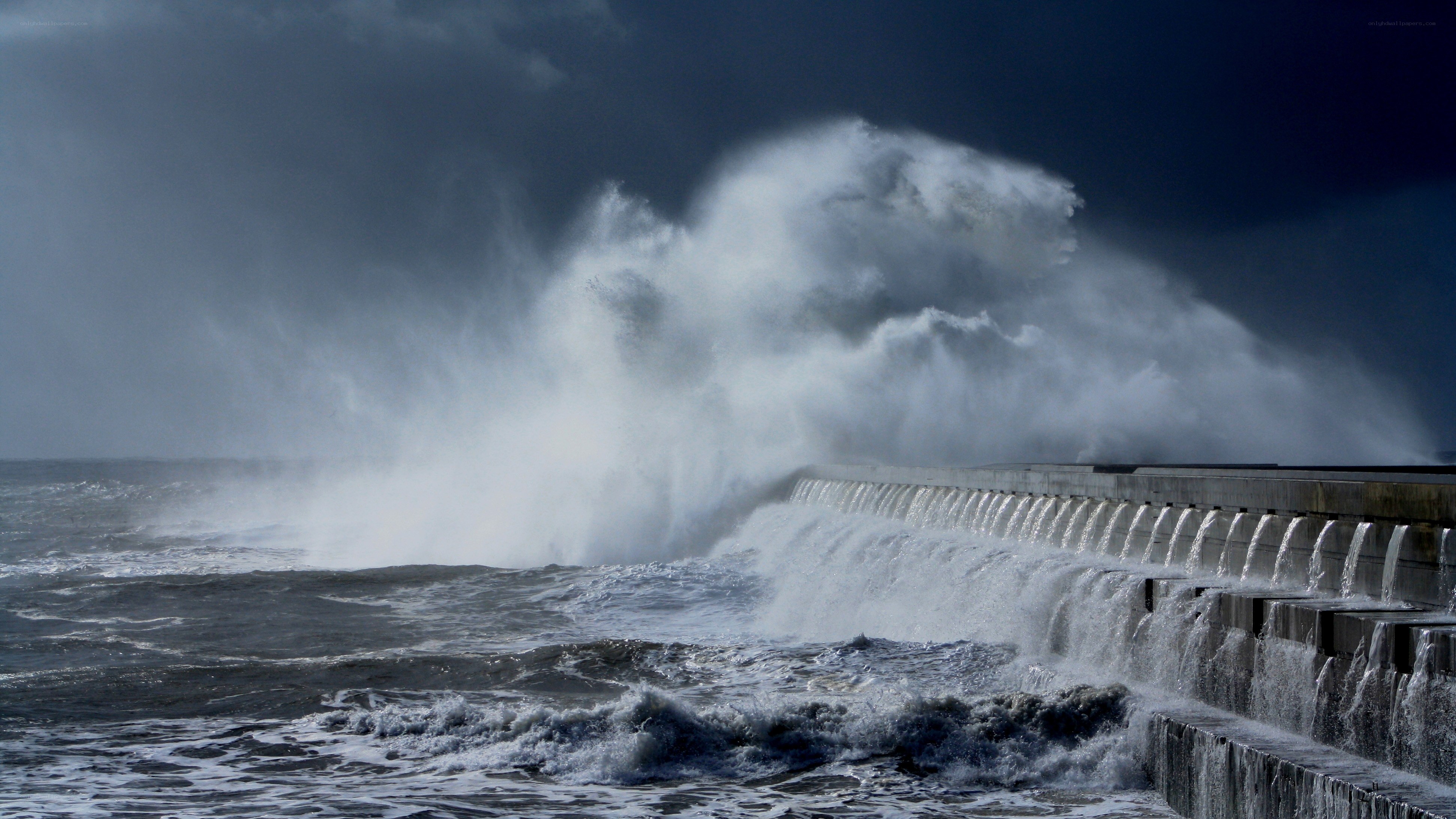 Waves crashing on sea wall