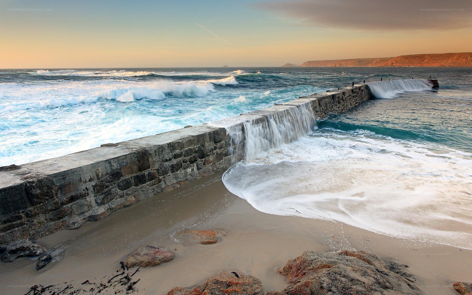 Waves crashing on stone pier