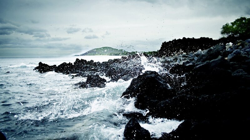 Waves crashing on volcanic rocks