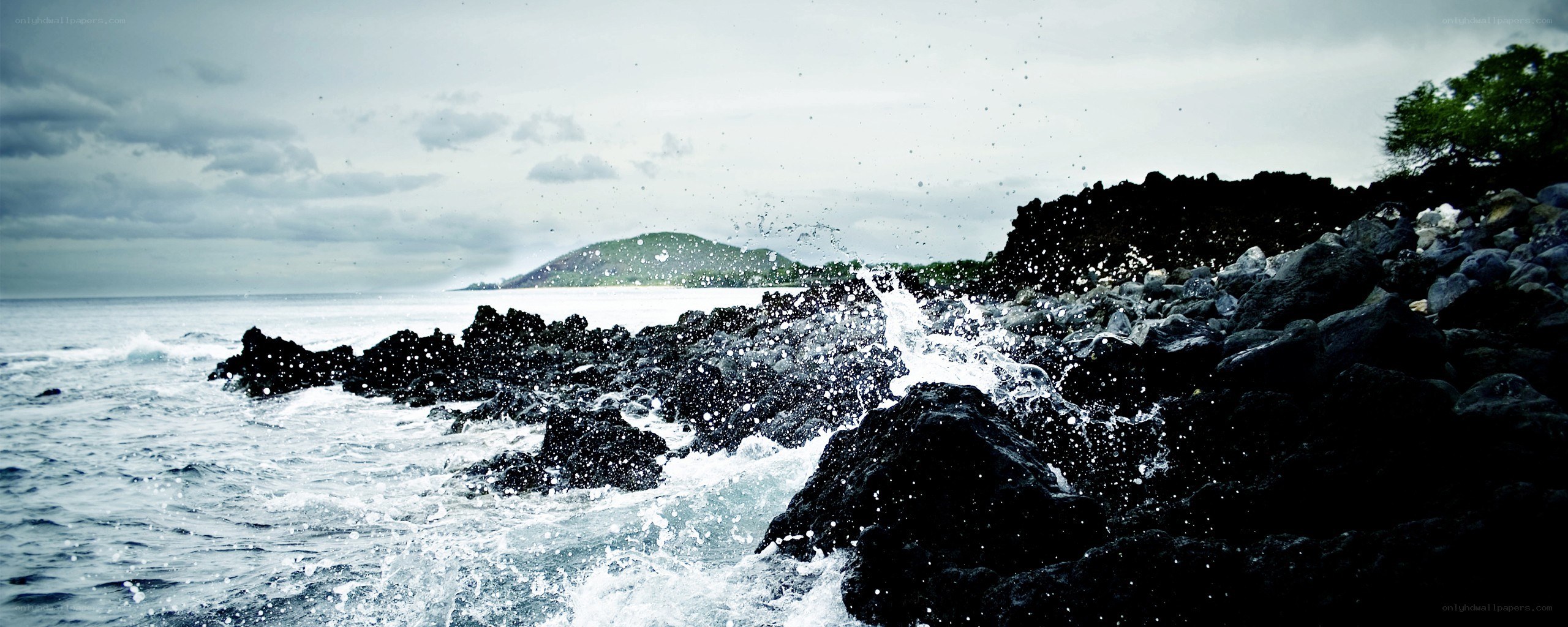 Waves crashing on volcanic rocks
