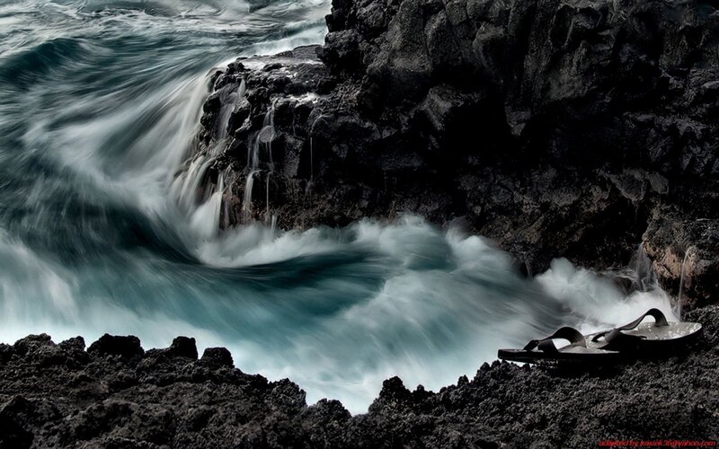 Waves crashing on volcanic rocks