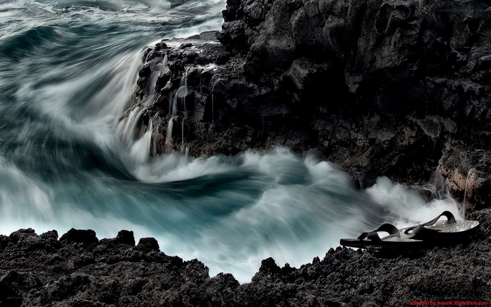 Waves crashing on volcanic rocks