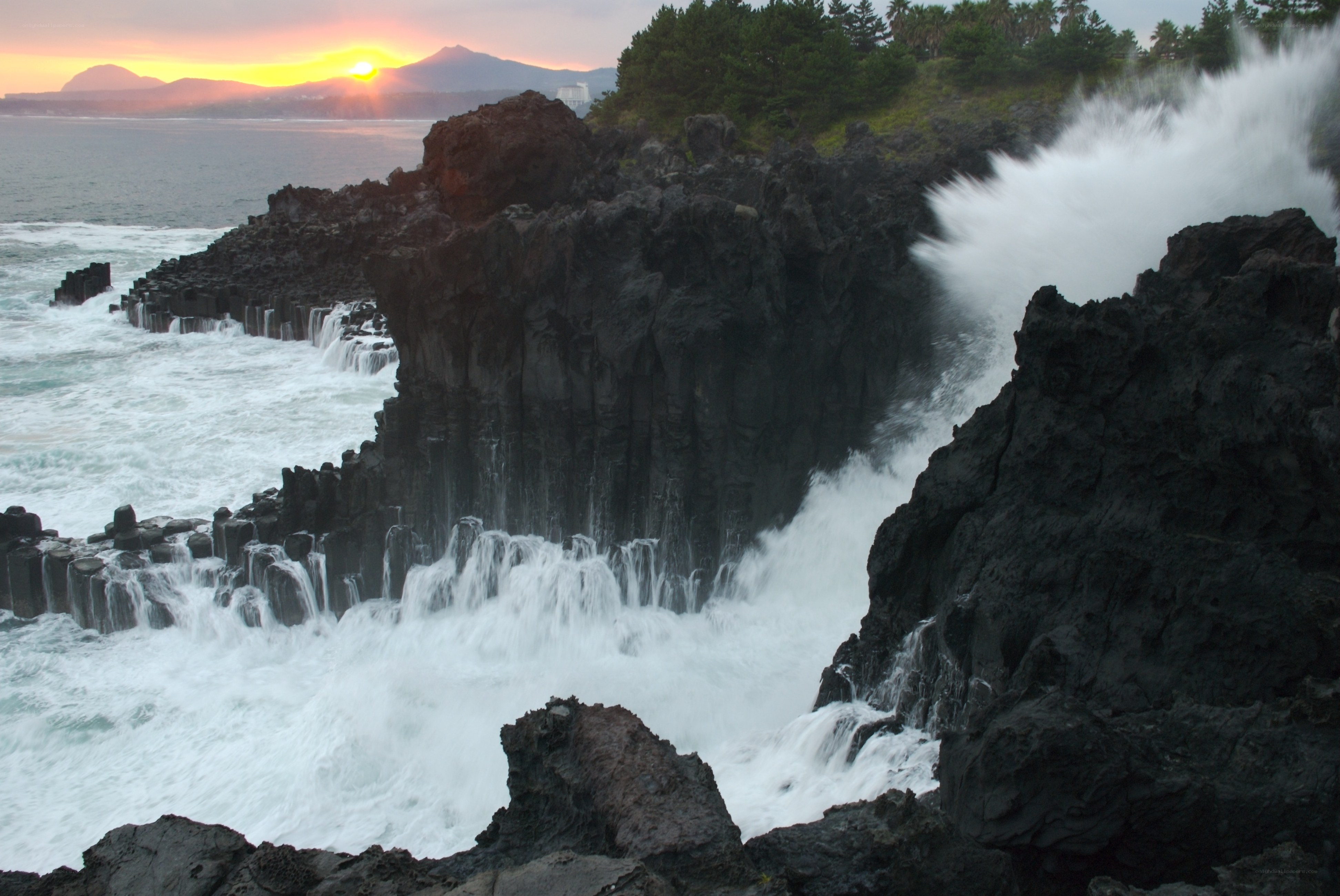 Waves crashing on volcanic rocks