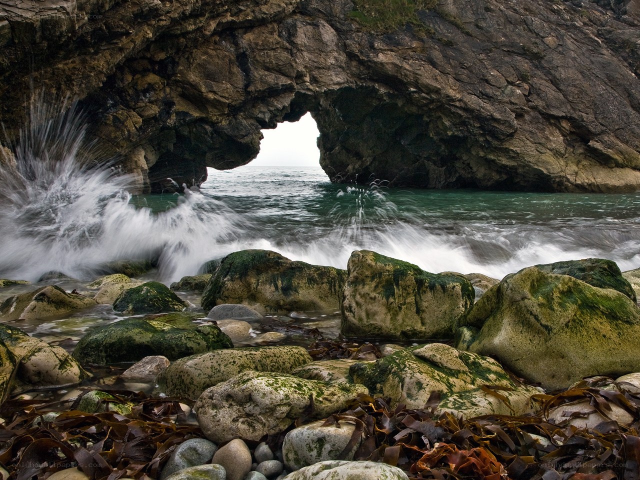 Waves crashing through a sea arch