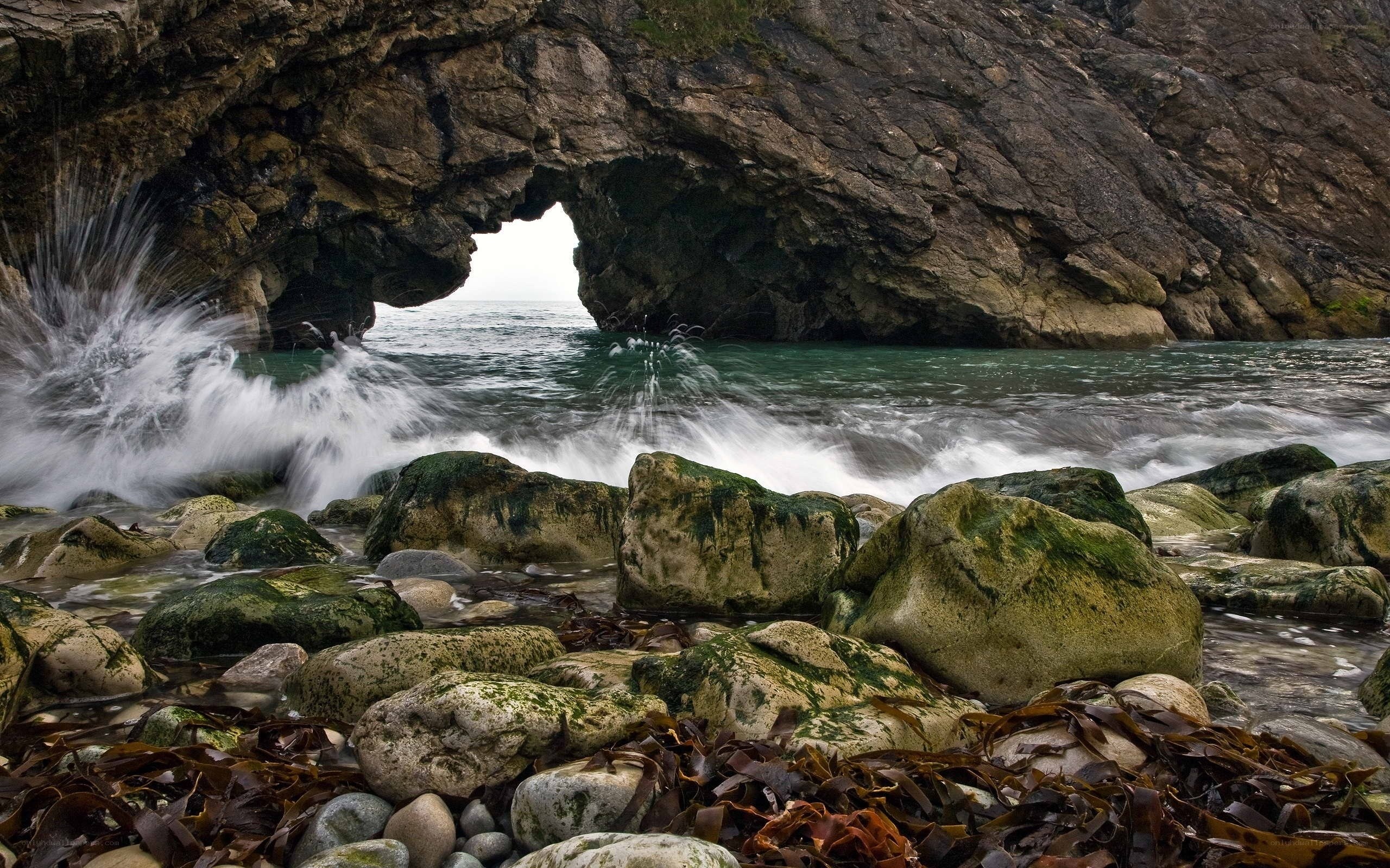 Waves crashing through sea arch