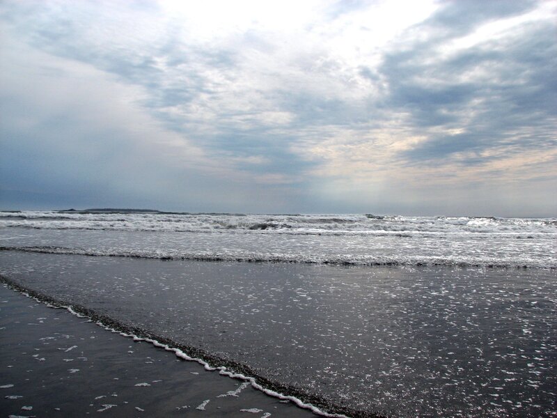Waves on a cloudy beach