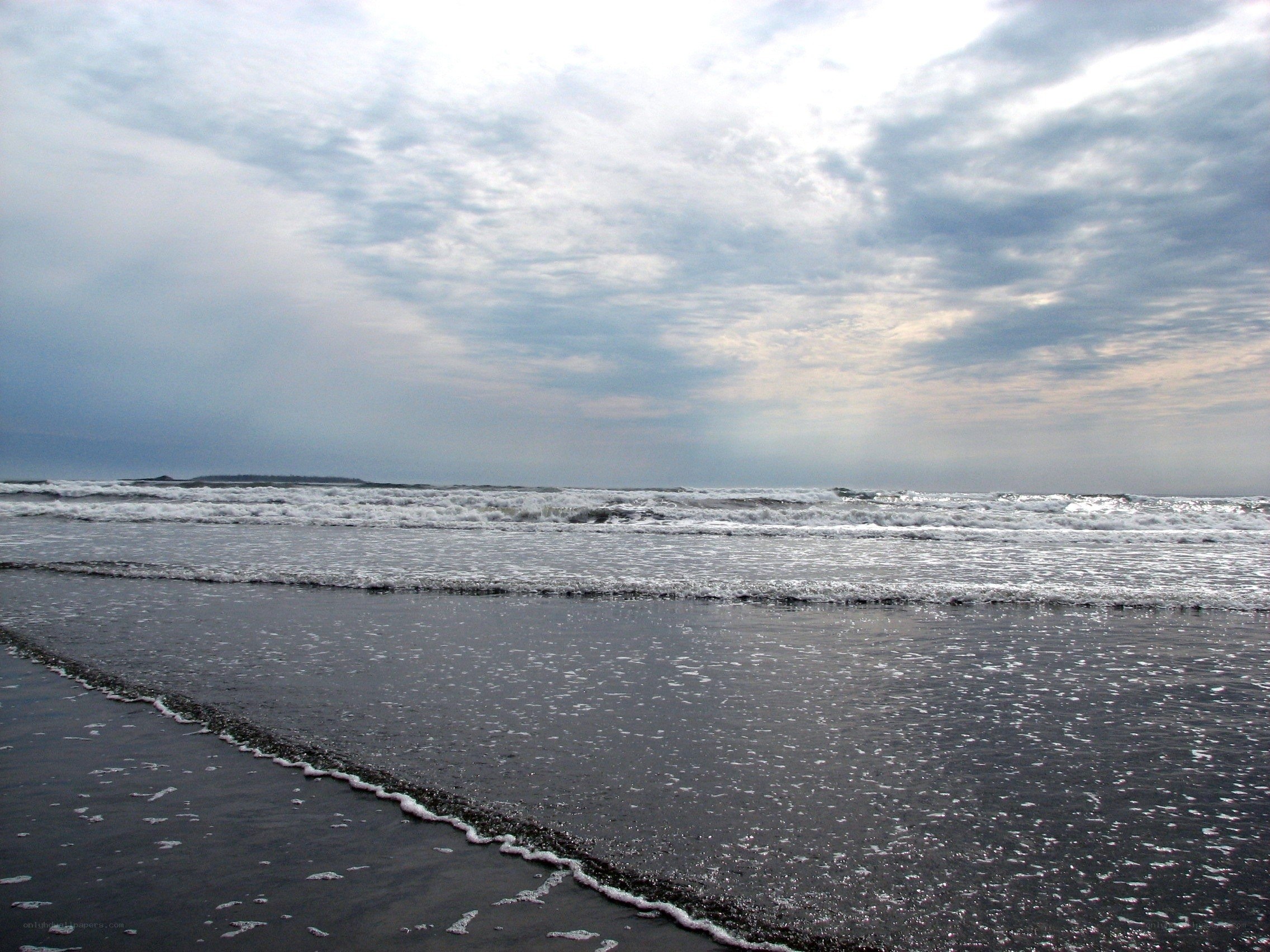 Waves on a cloudy beach