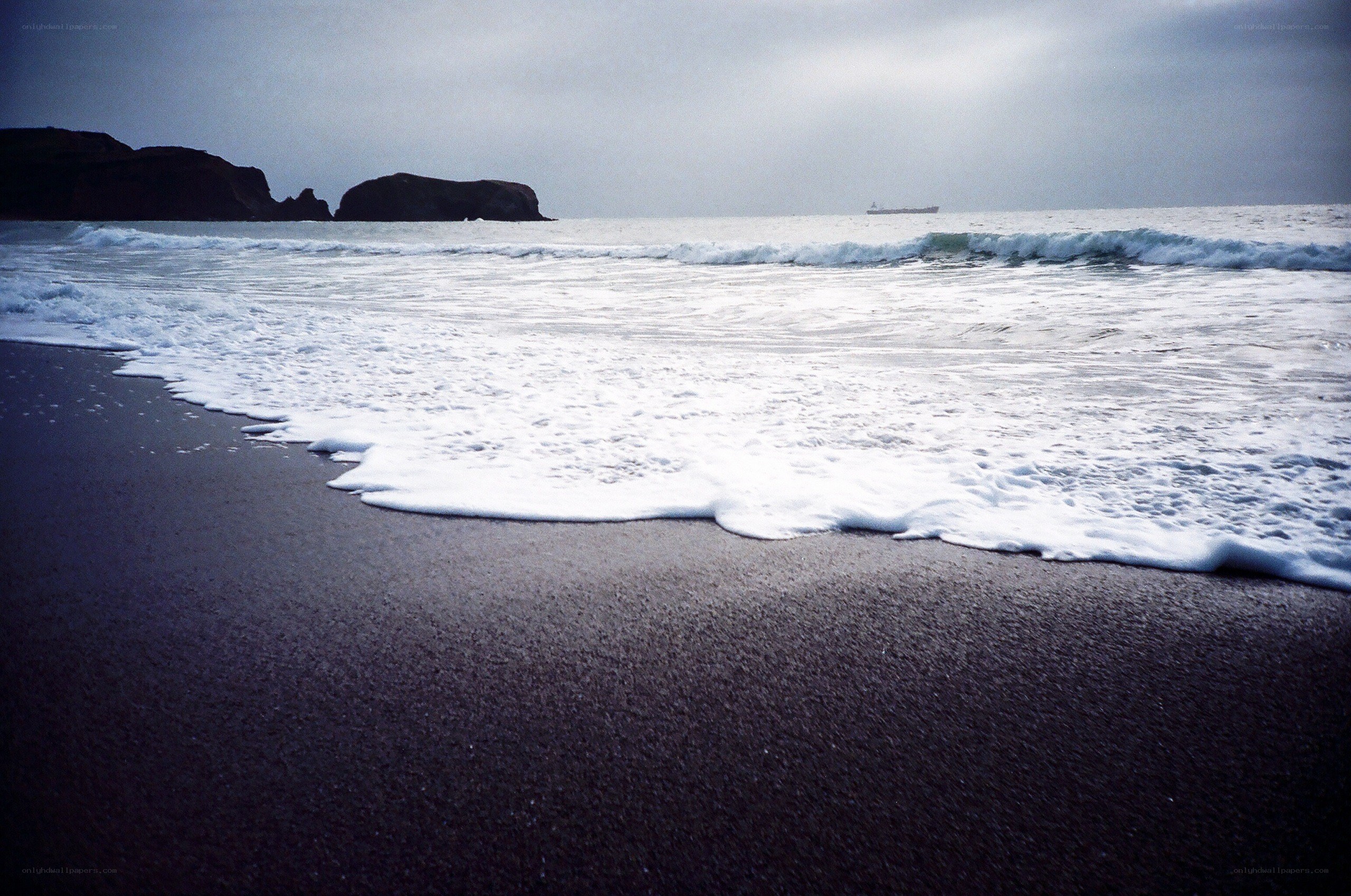 Waves on a dark beach