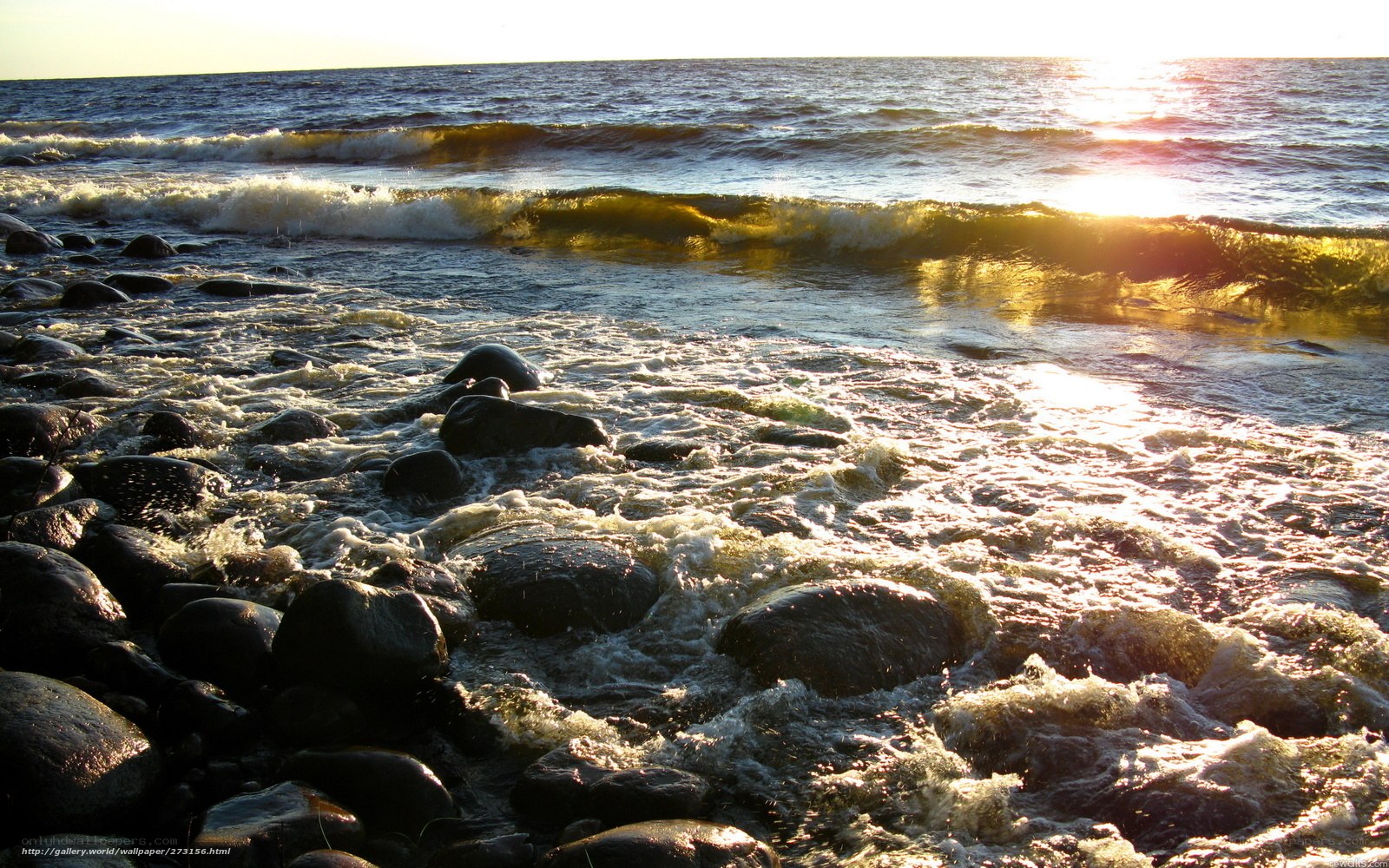 Waves on a rocky shore at sunset