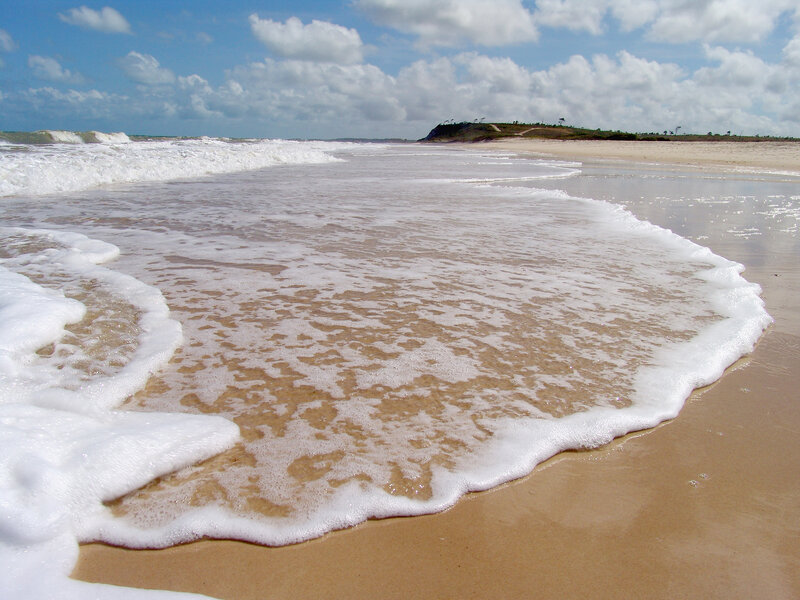 Waves washing onto sandy beach