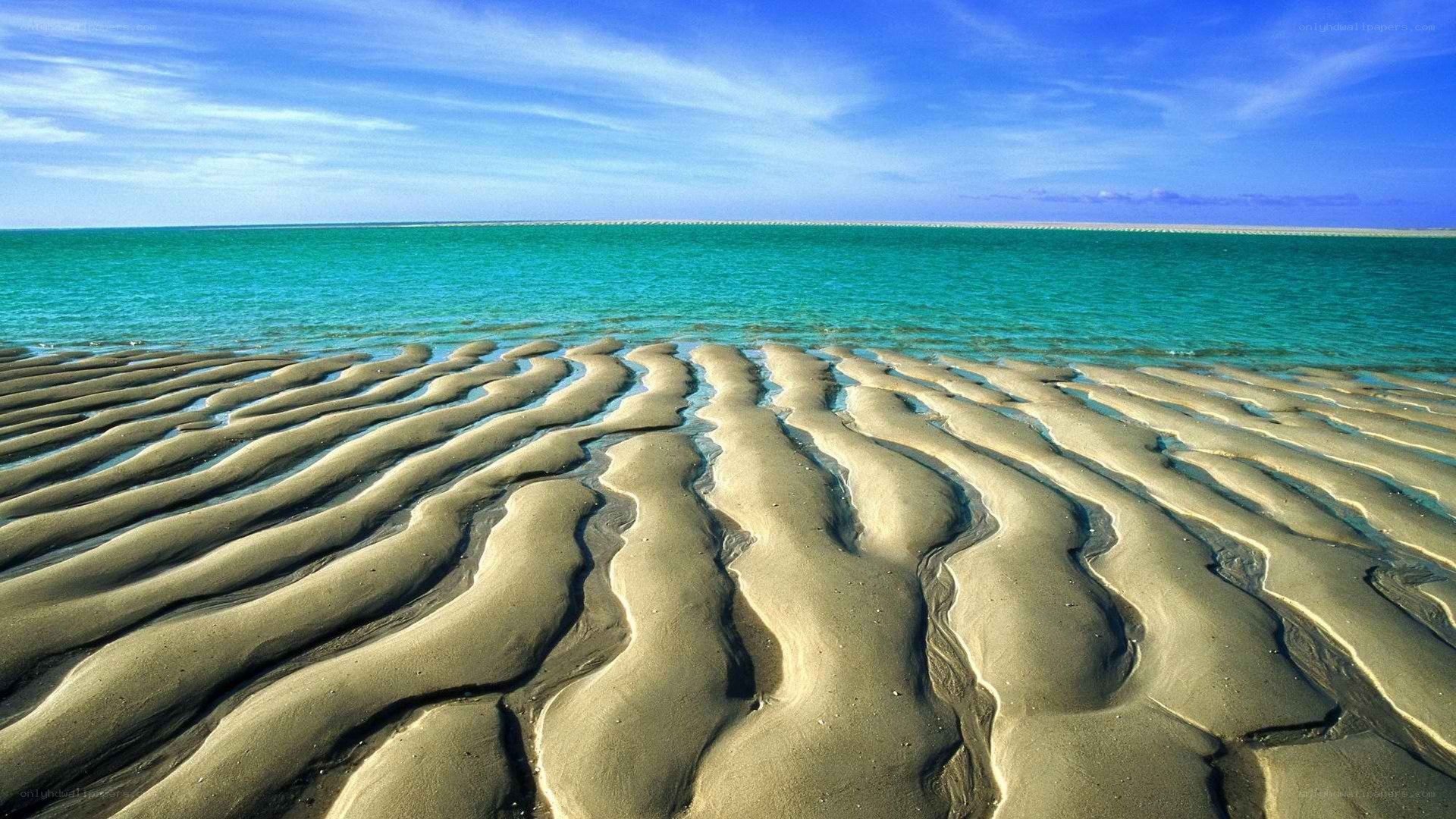 Wavy sand patterns on a beach