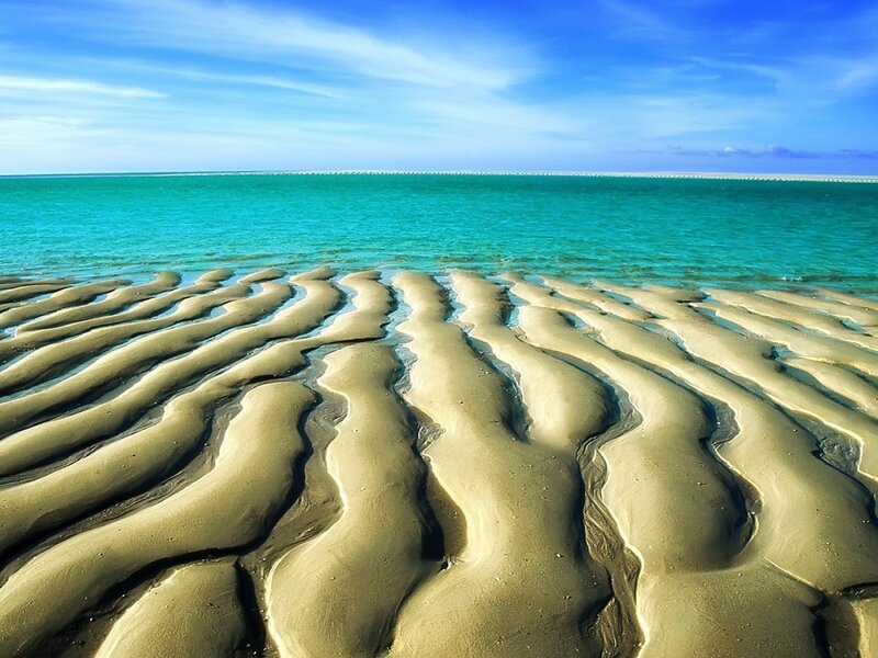 Wavy sand patterns on a beach