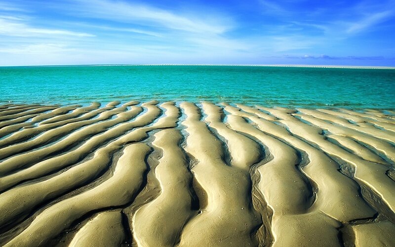 Wavy sand patterns on beach