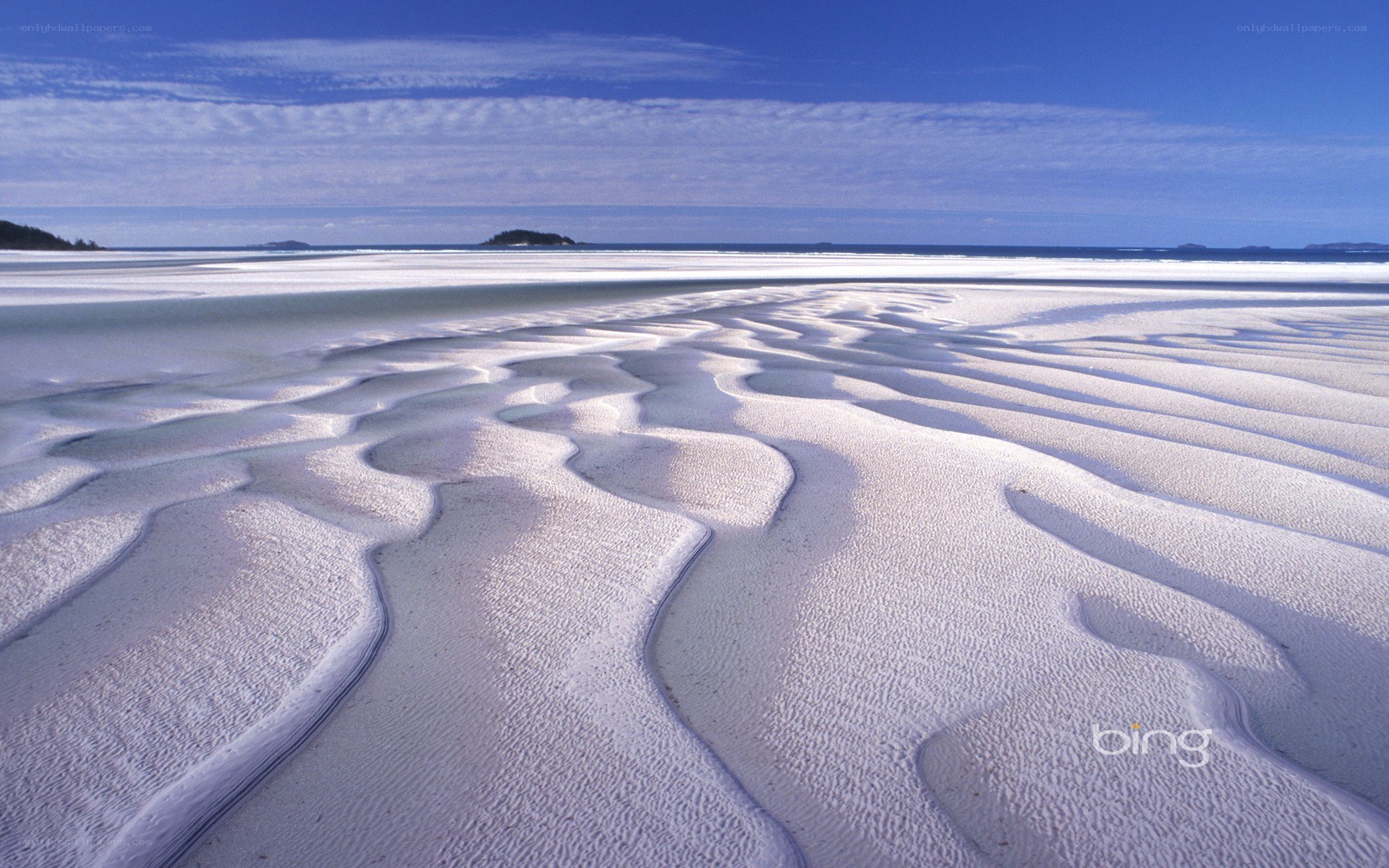 Wavy sand patterns on beach