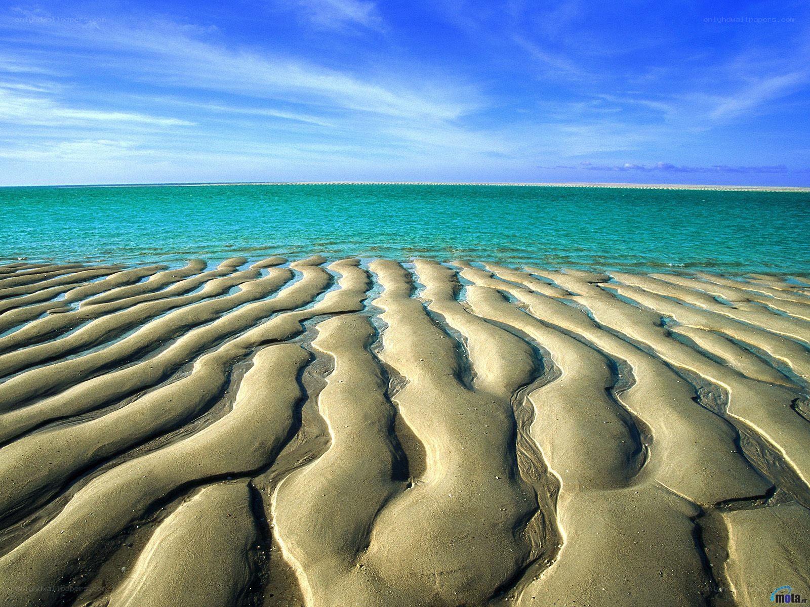 Wavy sand patterns on beach