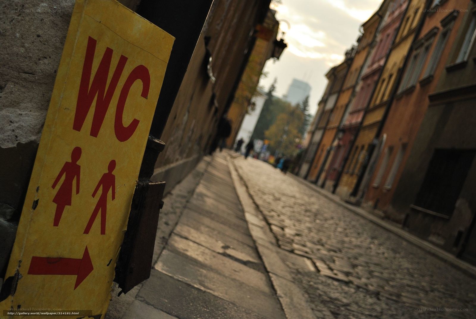WC sign on cobblestone street