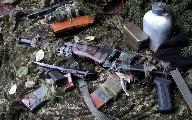 Weapons and gear in camouflage net