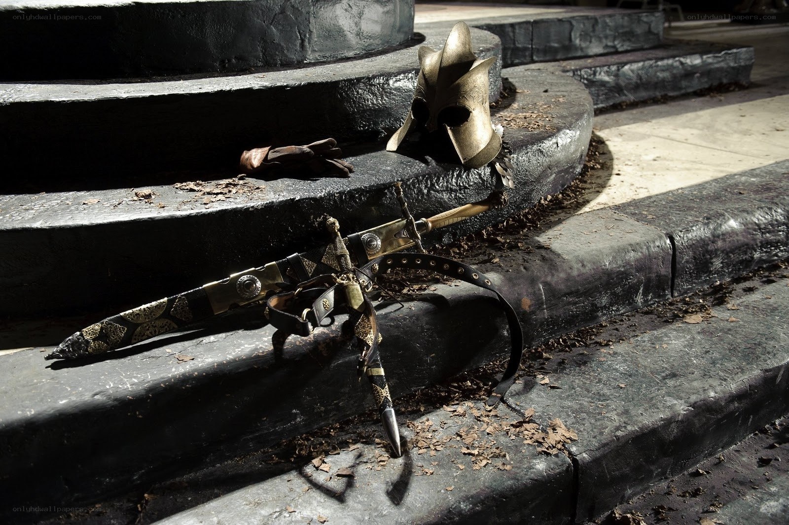 Weapons and helmet on stone steps