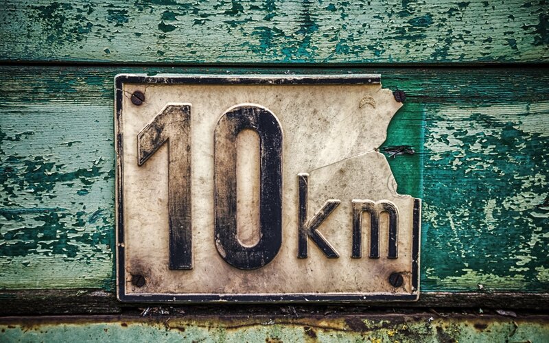 weathered 10km sign