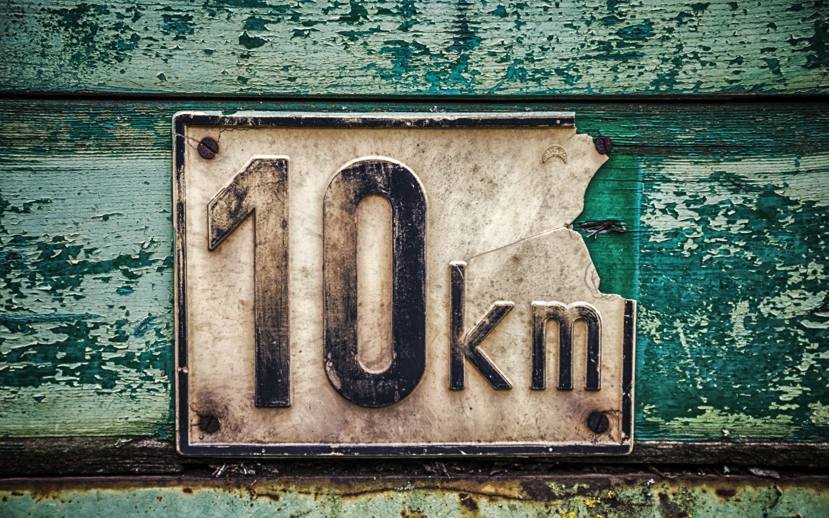 weathered 10km sign