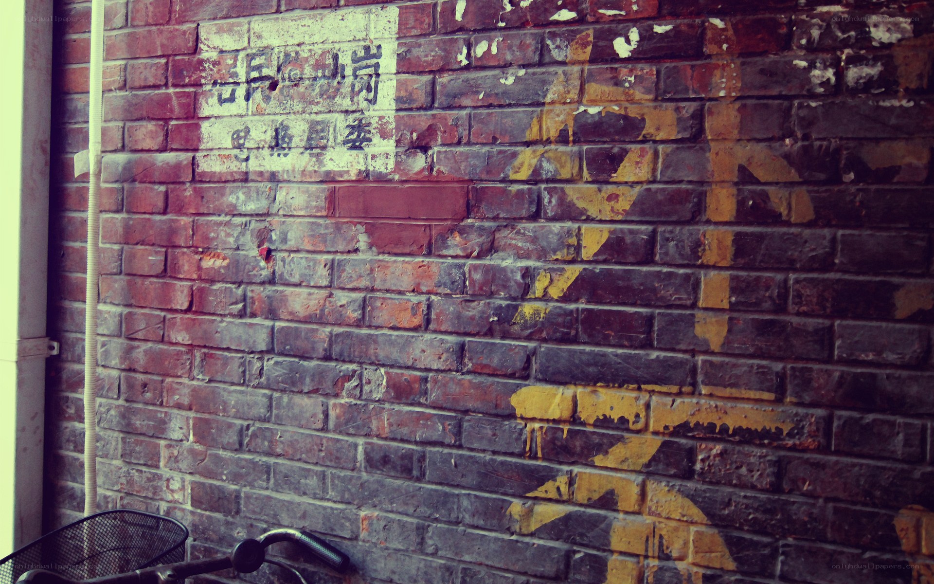 weathered brick wall with faded sign
