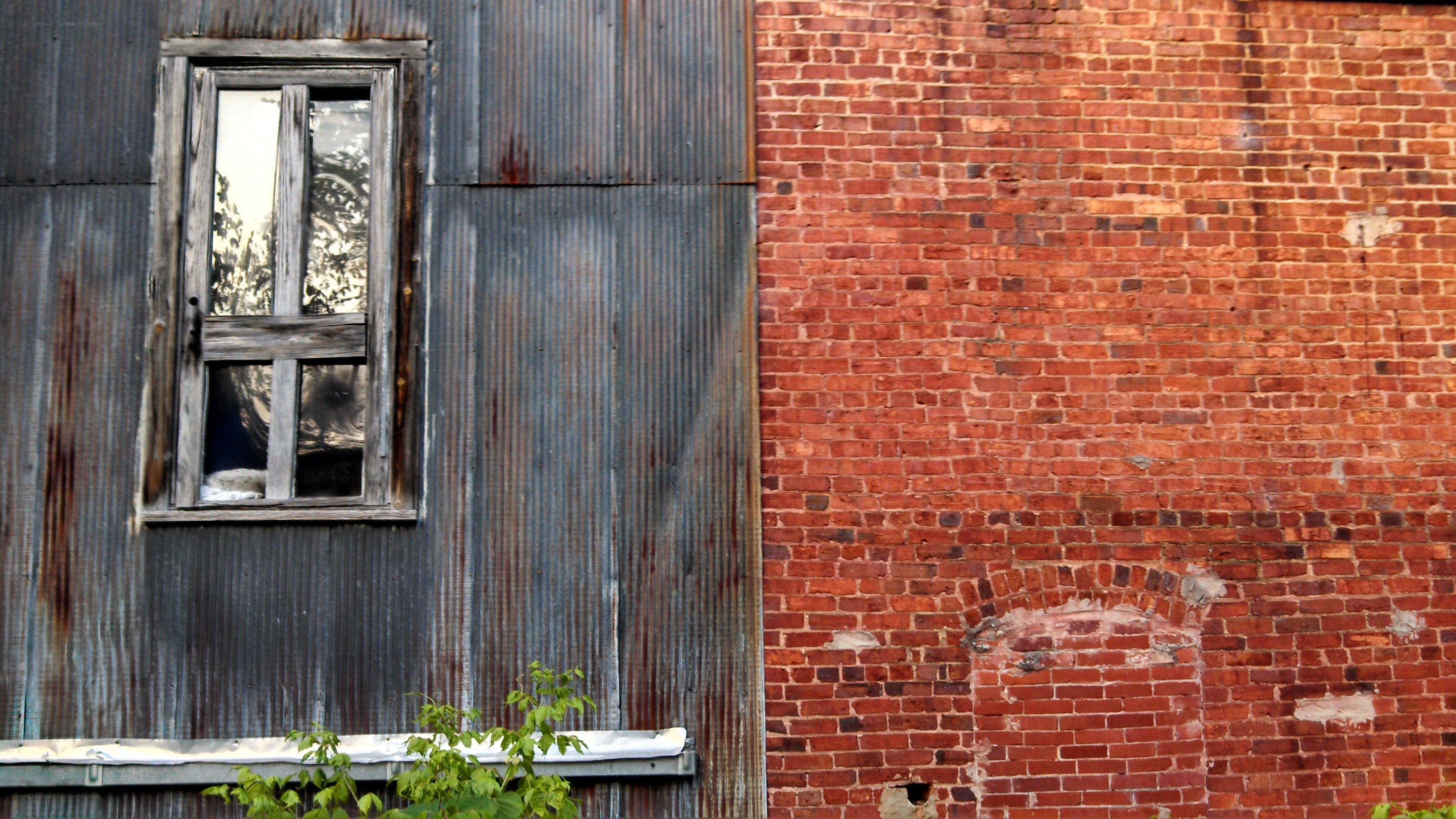 weathered building with brick and metal