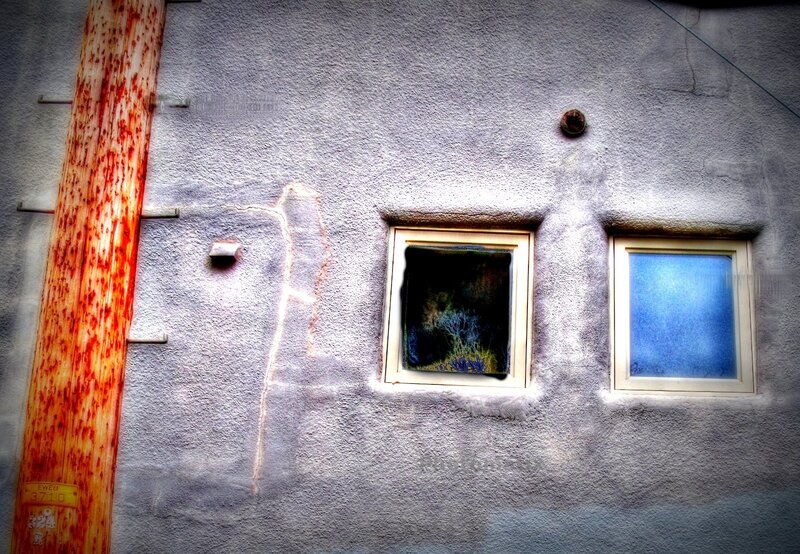 weathered building with two windows