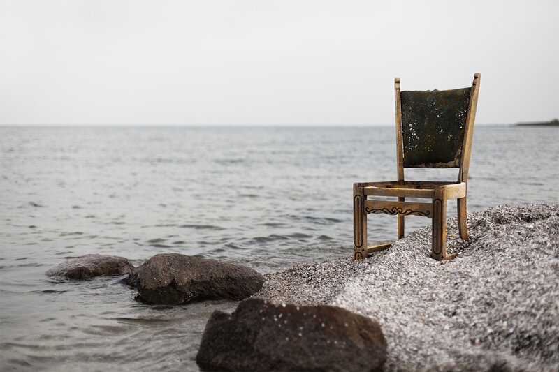 Weathered Chair on Shore