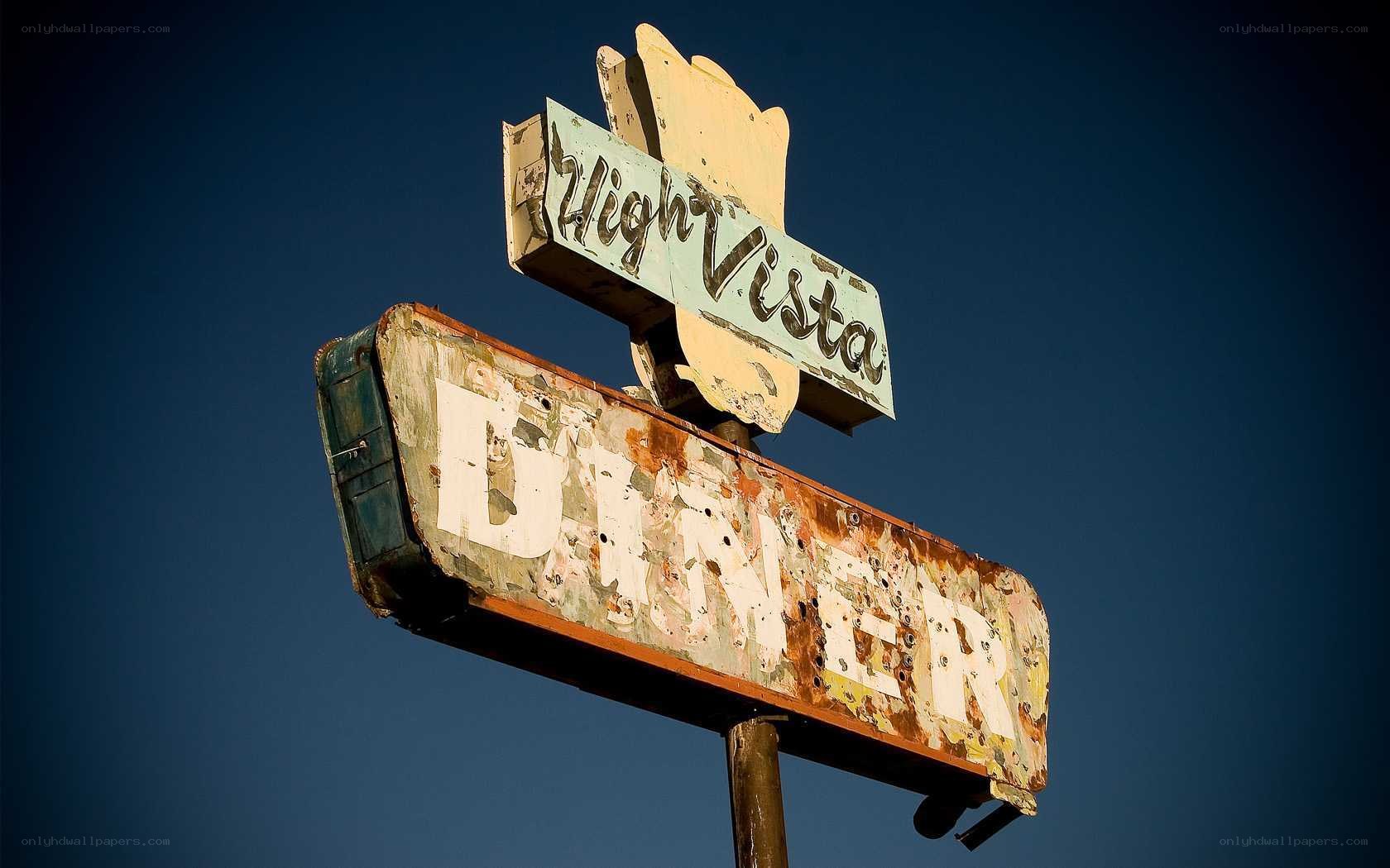 weathered diner sign at dusk