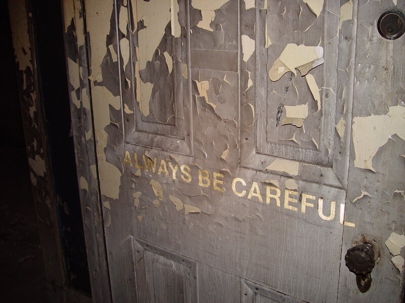 weathered door with warning text
