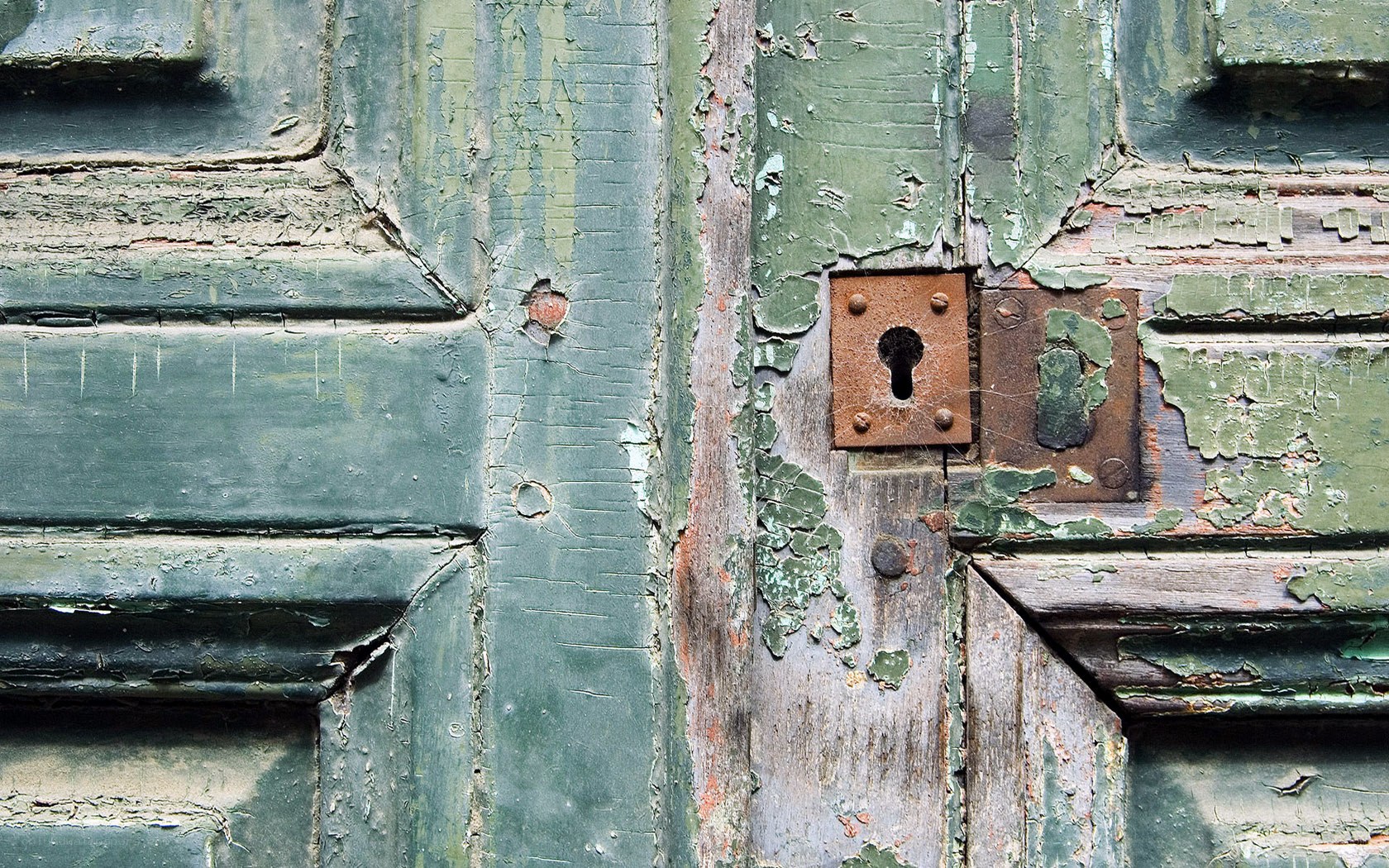 weathered green door with lock