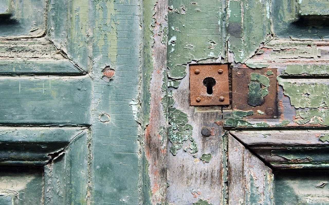weathered green door with lock