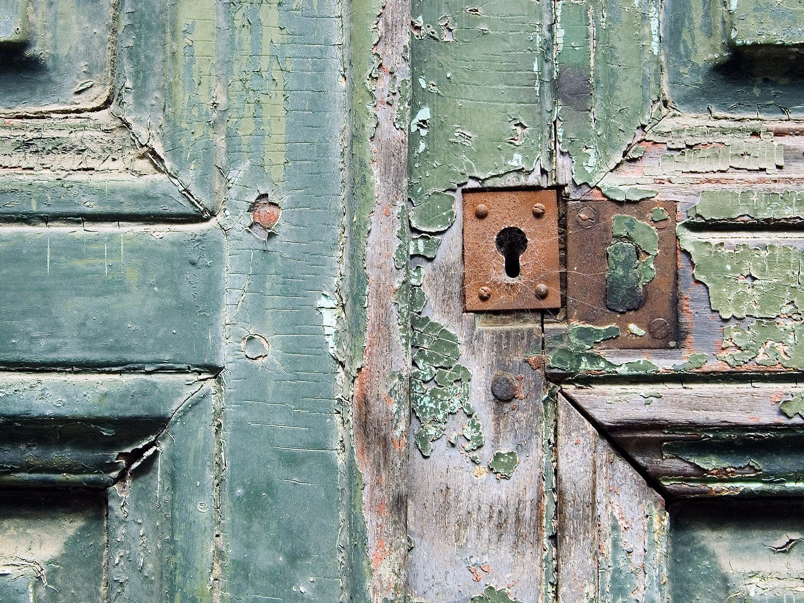 weathered green door with lock