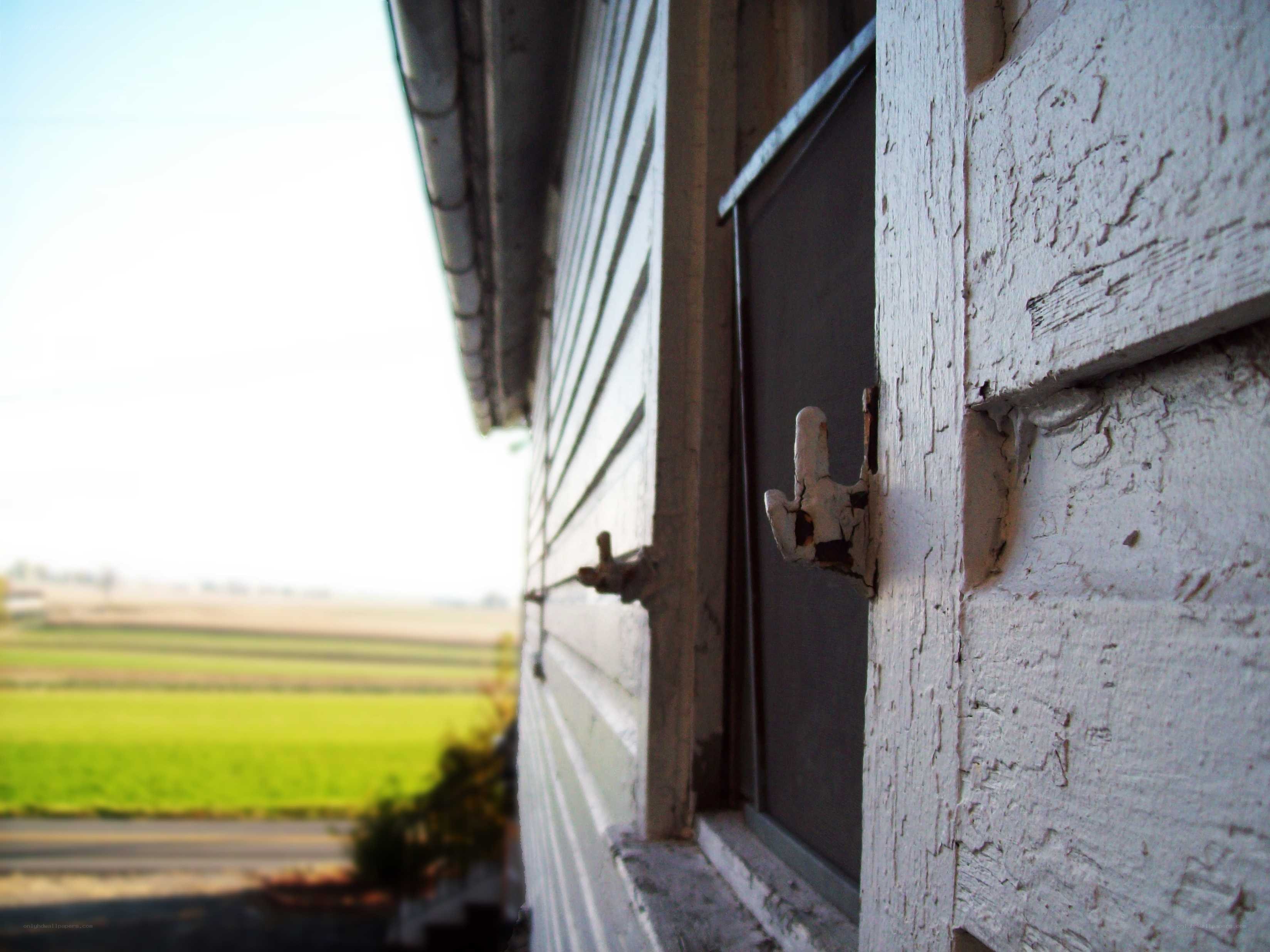 weathered house window with field view