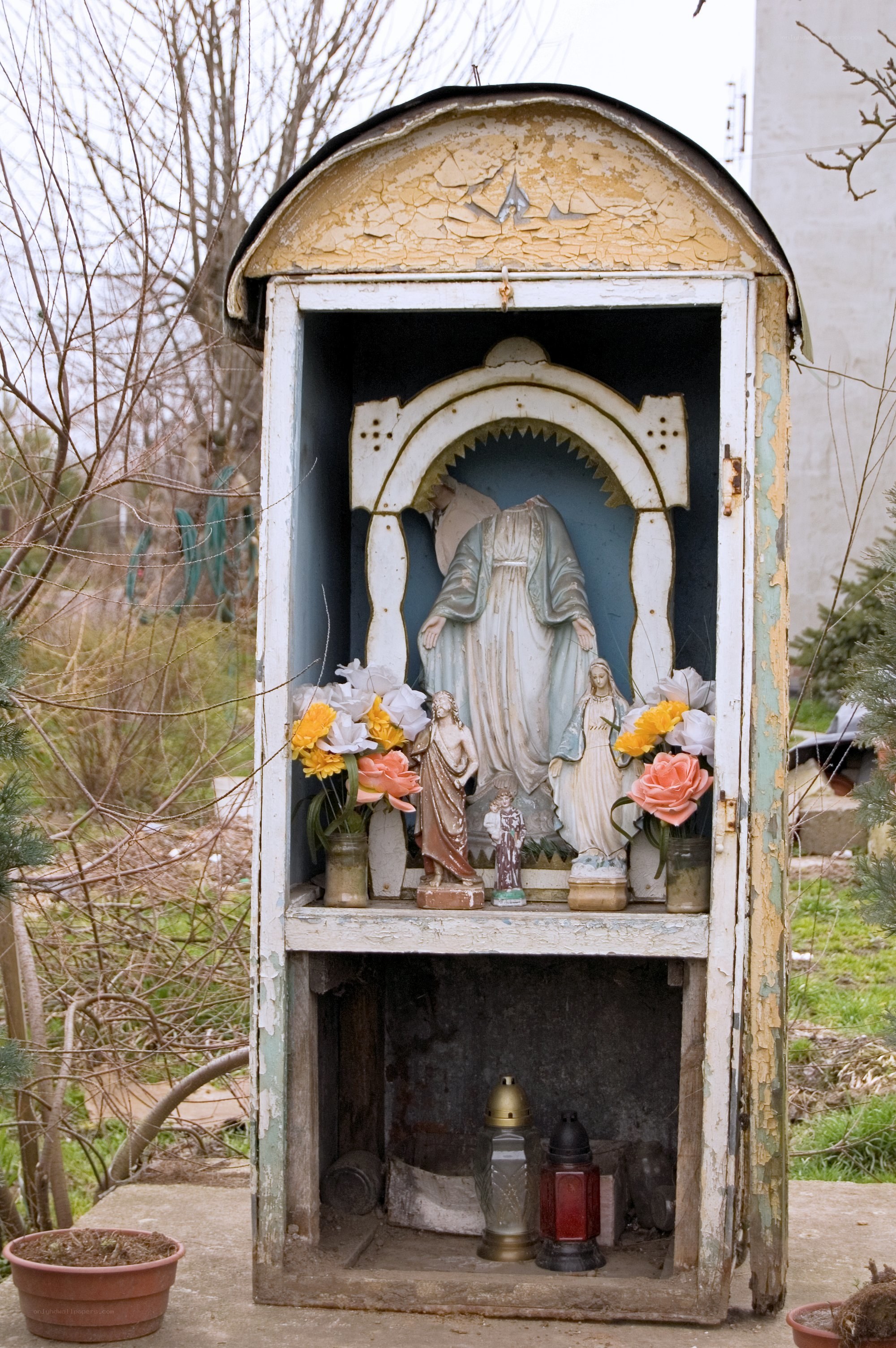 Weathered outdoor shrine with statues