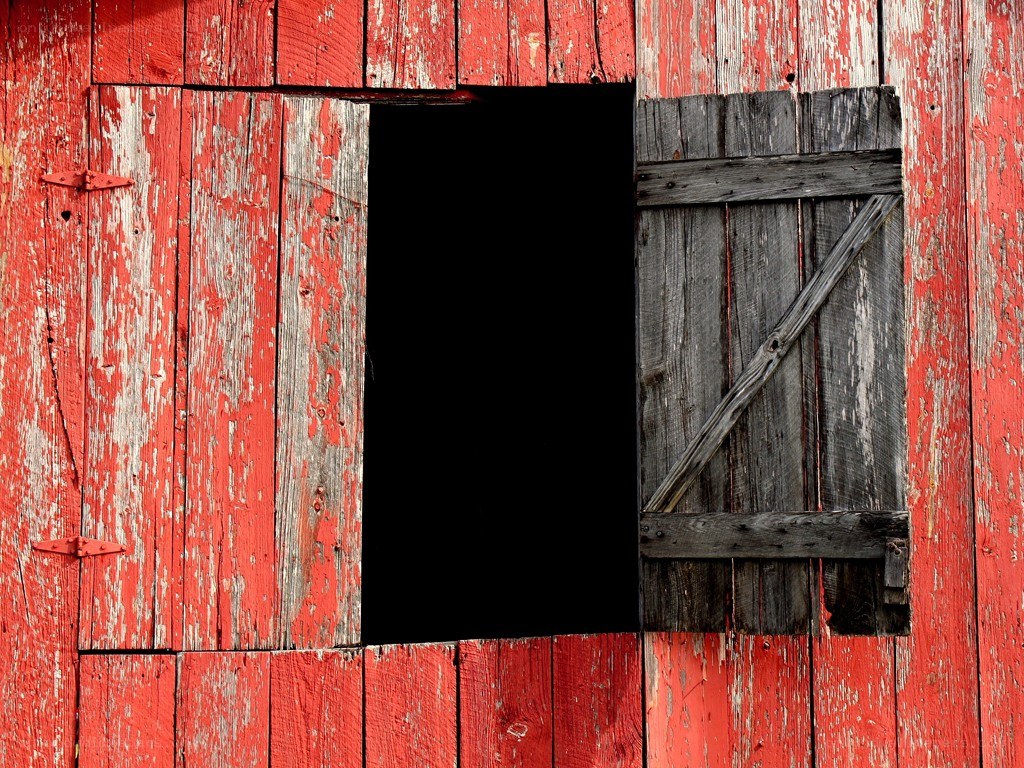 weathered red barn window