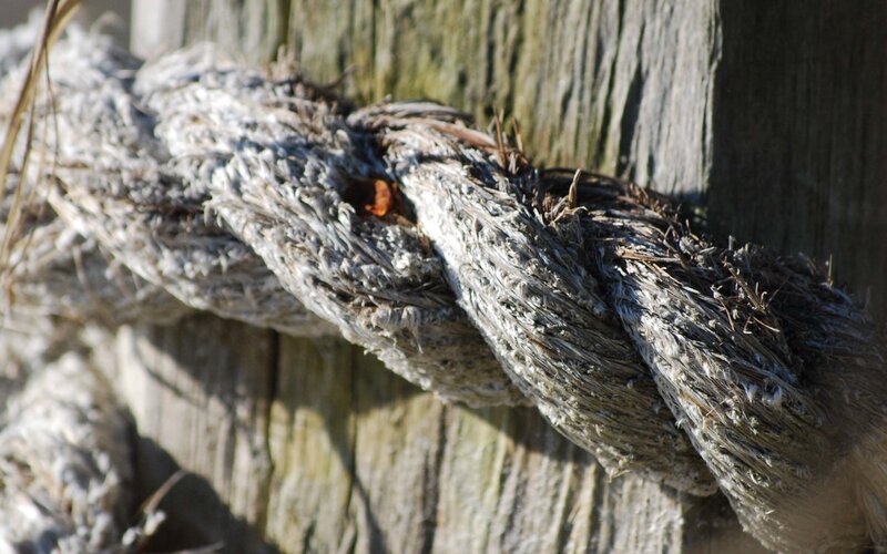 weathered rope on wooden post
