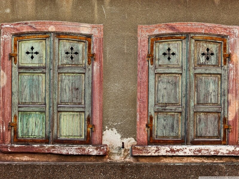 Weathered shutters on old building