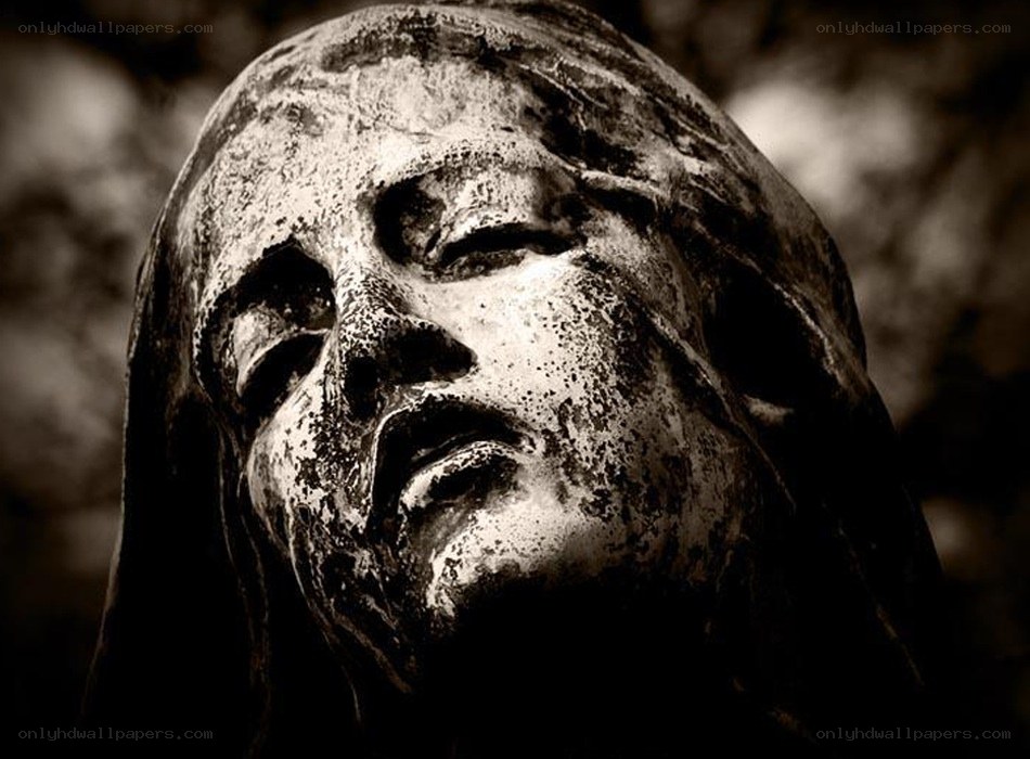 weathered stone face sculpture