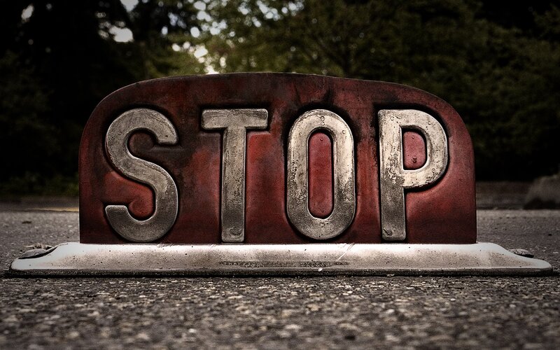 weathered stop sign on pavement