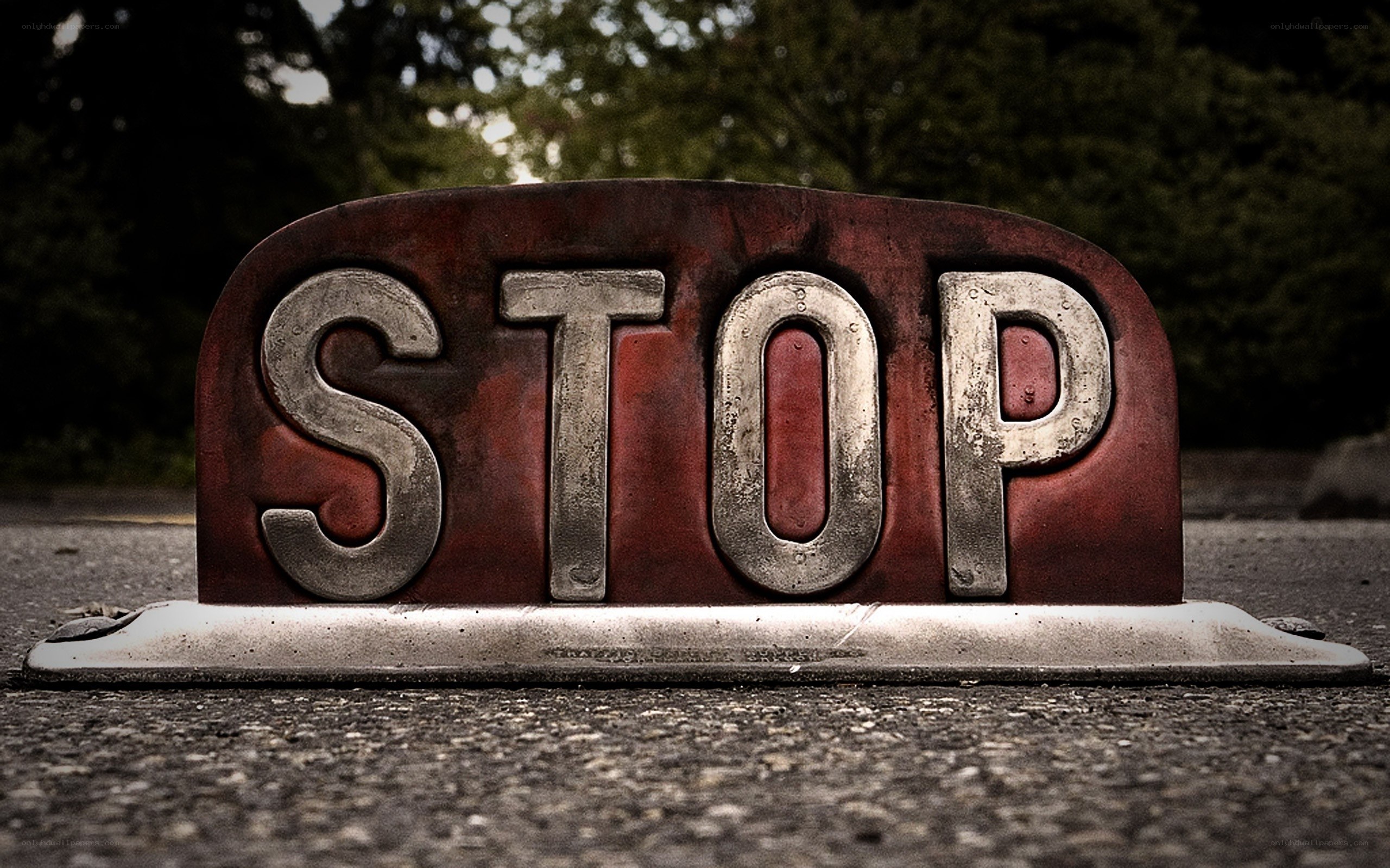 weathered stop sign on pavement