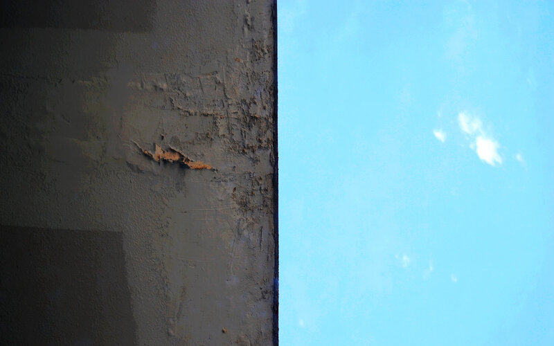 weathered wall against blue sky